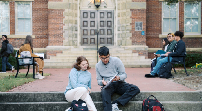 Get back to the work that feeds your soul | Dr. Greg DeLoach Two Mercer students sit on steps outside a building, studying together with backpacks nearby; others sit on benches in the background.