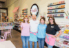 Professor opens sweet shop in downtown Macon Four staff members stand together inside a colorful ice cream and candy shop, smiling at the camera.