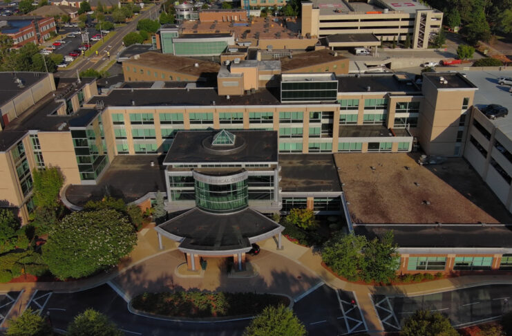 Aerial view of a Tanner Health medical complex with multiple buildings, parking areas, and landscaped greenery.