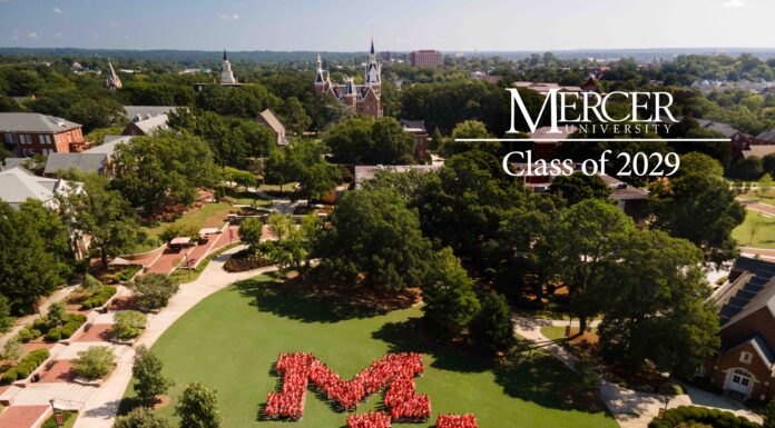 Mercer enrolls record freshman class Aerial view of students in red shirts forming MU on a campus lawn, labeled Mercer University Class of 2029.