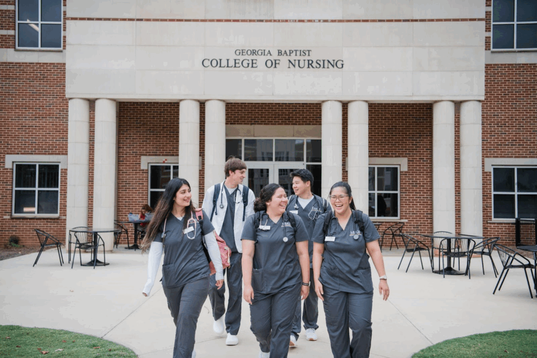 Five nursing students walk and talk outside the Georgia Baptist College of Nursing building.