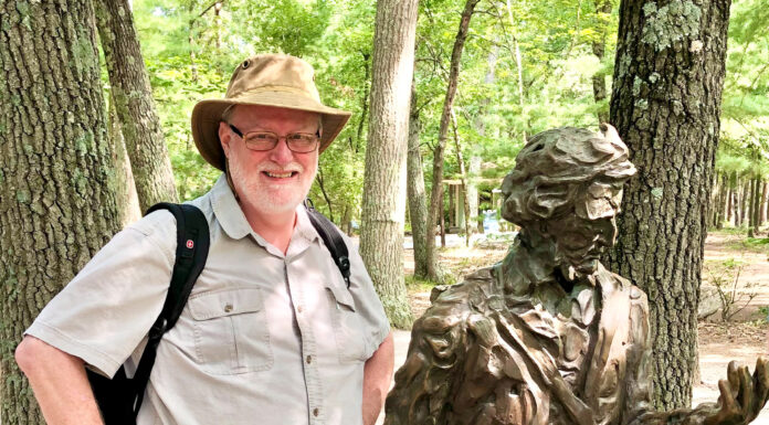 Faculty member elected to leadership role in prestigious Thoreau Society Dr. Marc Jolley stands next to a bronze statue of Henry David Thoreau in a wooded outdoor setting.