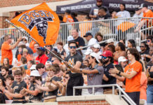 3 things to know about Mercer vs. VMI football game day: Oct. 25, 2025 A crowd watches a football game as a man waves a Mercer University Bears flag in the stands.