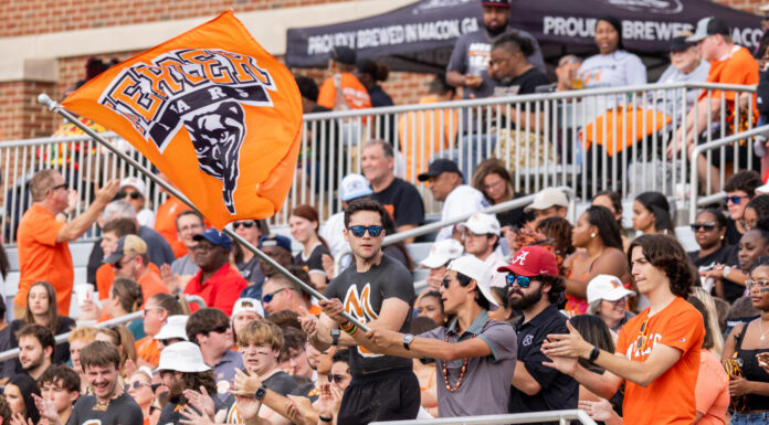 3 things to know about Mercer vs. VMI football game day: Oct. 25, 2025 A crowd watches a football game as a man waves a Mercer University Bears flag in the stands.