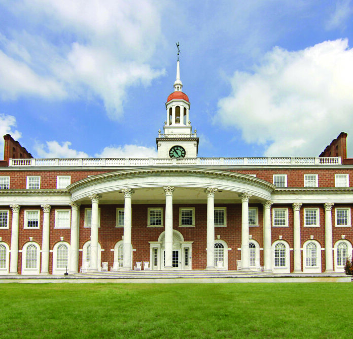 Front view of Mercer Law School on a green lawn.