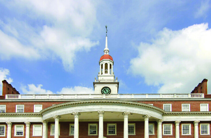 Front view of Mercer Law School on a green lawn.