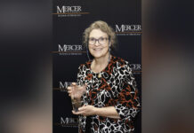 Dr. Donna Evans named 2025 Sandra Dunagan Deal Rural Service Fellow Donna Evans holding a glass award.