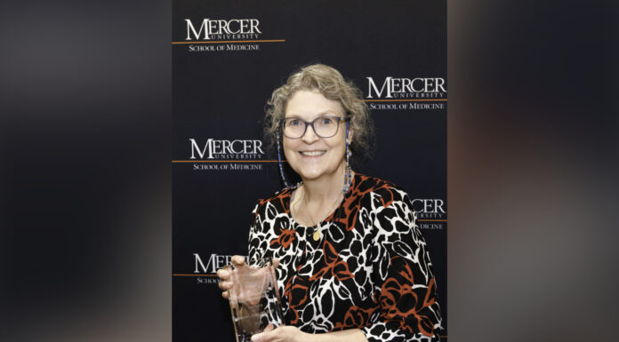 Dr. Donna Evans named 2025 Sandra Dunagan Deal Rural Service Fellow Donna Evans holding a glass award.