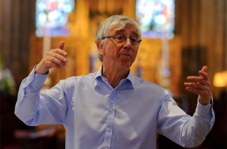 Stephen Darlington conducting in a church.