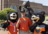 Mercer to welcome alumni and friends Nov. 14-15 for Homecoming 2025 A person in a Mercer University shirt poses with two bear mascots in front of a bear statue on campus.