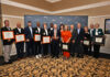 10th annual Alumni Awards Reception recognizes outstanding Mercerians A group of people stand indoors holding awards and framed certificates in front of a Mercer University backdrop.
