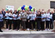 Kids Alliance for Better Care celebrates Dodge County Hospital’s emergency department as part of the Pediatric Emergency Care Project A group of people pose for a ribbon-cutting ceremony outside a building, with balloons and a kidsABC banner in the background.