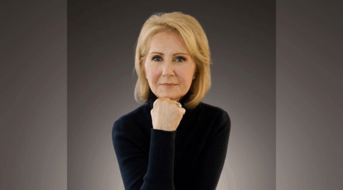 Mercerian’s World War II book picked up by leading publisher A woman with blond hair wearing a black turtleneck poses with her chin resting on her hand against a dark background.