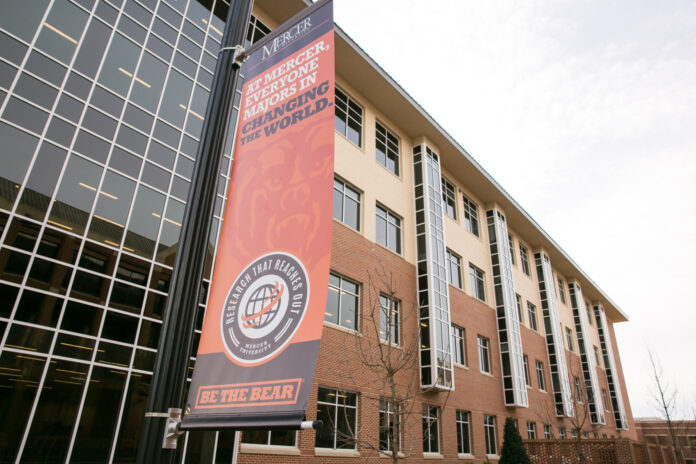 1801_SciBuildingFirstDay_CiSmith-380 Banner outside the Godsey Science Center reads At Mercer, everyone majors in changing the world.