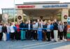 Kids Alliance for Better Care celebrates Colquitt Regional Medical Center’s emergency department as part of the Pediatric Emergency Care Project A group of people stands outside a hospital entrance, holding a large blue ribbon for a ribbon-cutting ceremony.