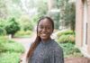 Mercerian selected for Duke Cancer Institute’s DIRECT Fellowship Young woman with braided hair smiles outdoors, standing near a brick building with greenery in the background.