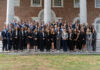 Mercer School of Law ranks No. 4 in elite Gavel Rankings A large group of professionally dressed people pose for a photo on outdoor steps in front of a brick building with columns.