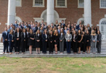 Mercer School of Law ranks No. 4 in elite Gavel Rankings A large group of professionally dressed people pose for a photo on outdoor steps in front of a brick building with columns.
