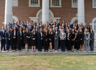 Mercer School of Law ranks No. 4 in elite Gavel Rankings A large group of professionally dressed people pose for a photo on outdoor steps in front of a brick building with columns.