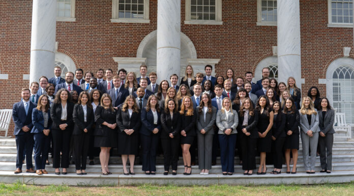 Mercer School of Law ranks No. 4 in elite Gavel Rankings A large group of professionally dressed people pose for a photo on outdoor steps in front of a brick building with columns.