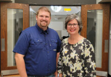 New podcast explores health care challenges, triumphs in rural Georgia Dr. Justin Peterson and Glenda Grant stand smiling inside a building entrance with open wooden doors.