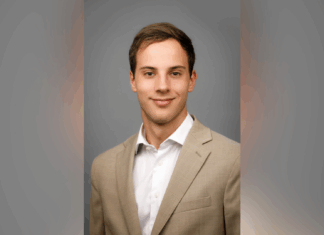 School of Engineering senior named Power and Energy Society Scholar A young man in a beige suit jacket and white shirt poses against a plain gray background.