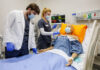 High-tech, real-life simulations prepare Mercer nursing students for practice Two Mercer nursing students practice patient care on a medical mannequin in a hospital room with monitoring equipment.
