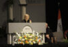 Nancy Grace to deliver 2026 Founders’ Day address A woman in academic regalia speaks at a podium decorated with flowers at a Mercer University event.