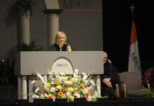 Nancy Grace to deliver 2026 Founders’ Day address A woman in academic regalia speaks at a podium decorated with flowers at a Mercer University event.