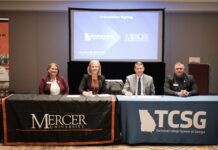 Mercer and Technical College System of Georgia sign transfer agreements to expand bachelor’s degree pathways Four people sit at tables with Mercer University and TCSG logos, signing an articulation agreement in a conference room.