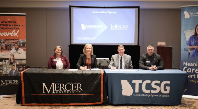 Mercer and Technical College System of Georgia sign transfer agreements to expand bachelor’s degree pathways Four people sit at tables with Mercer University and TCSG logos, signing an articulation agreement in a conference room.