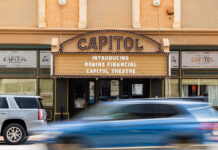 Mercer acquires downtown Macon’s historic Capitol Theatre Capitol Theatre marquee reads Introducing Robins Financial Capitol Theatre with cars passing by in front.
