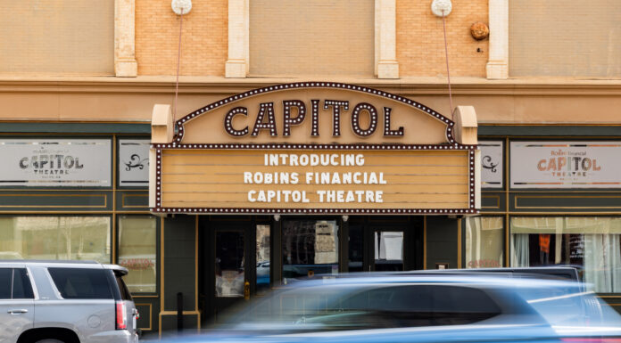 Mercer acquires downtown Macon’s historic Capitol Theatre Capitol Theatre marquee reads Introducing Robins Financial Capitol Theatre with cars passing by in front.