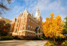 Mercer again named a top beautiful college campus by U.S. News & World Report Historic brick building with pointed towers surrounded by autumn trees under a partly cloudy sky.