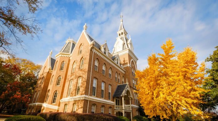 Mercer again named a top beautiful college campus by U.S. News & World Report Historic brick building with pointed towers surrounded by autumn trees under a partly cloudy sky.
