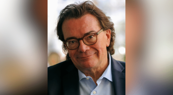 Editor and radio/podcast host Chuck Reece to deliver annual Byington Lecture A middle-aged man with glasses and dark hair, wearing a suit jacket and light blue shirt, smiles at the camera.