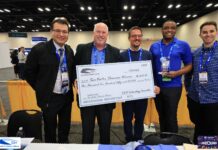 Mercer simulation devices aim to fill need in rural medical training Five men stand together at an event, holding a large ceremonial check for $1,250 made out to Sim Vortex Showcase Winners.