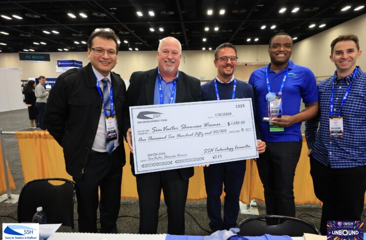 Five men stand together at an event, holding a large ceremonial check for $1,250 made out to Sim Vortex Showcase Winners.