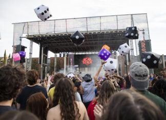 B.o.B, Hot Chelle Rae to headline Bearstock music festival Outdoor concert crowd tosses large inflatable dice in front of a stage with Bear Stock on the screen.
