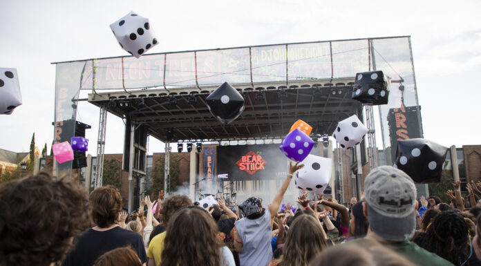 B.o.B, Hot Chelle Rae to headline Bearstock music festival Outdoor concert crowd tosses large inflatable dice in front of a stage with Bear Stock on the screen.