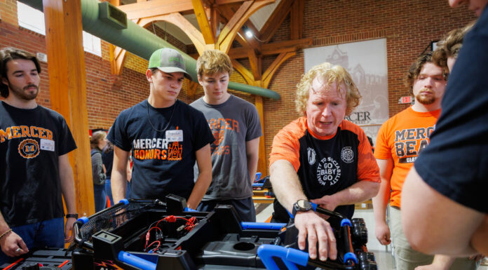 Engineering professor receives Joe and Jean Hendricks Excellence in Teaching Award A group of students gathers as an instructor explains parts of a modified toy car.