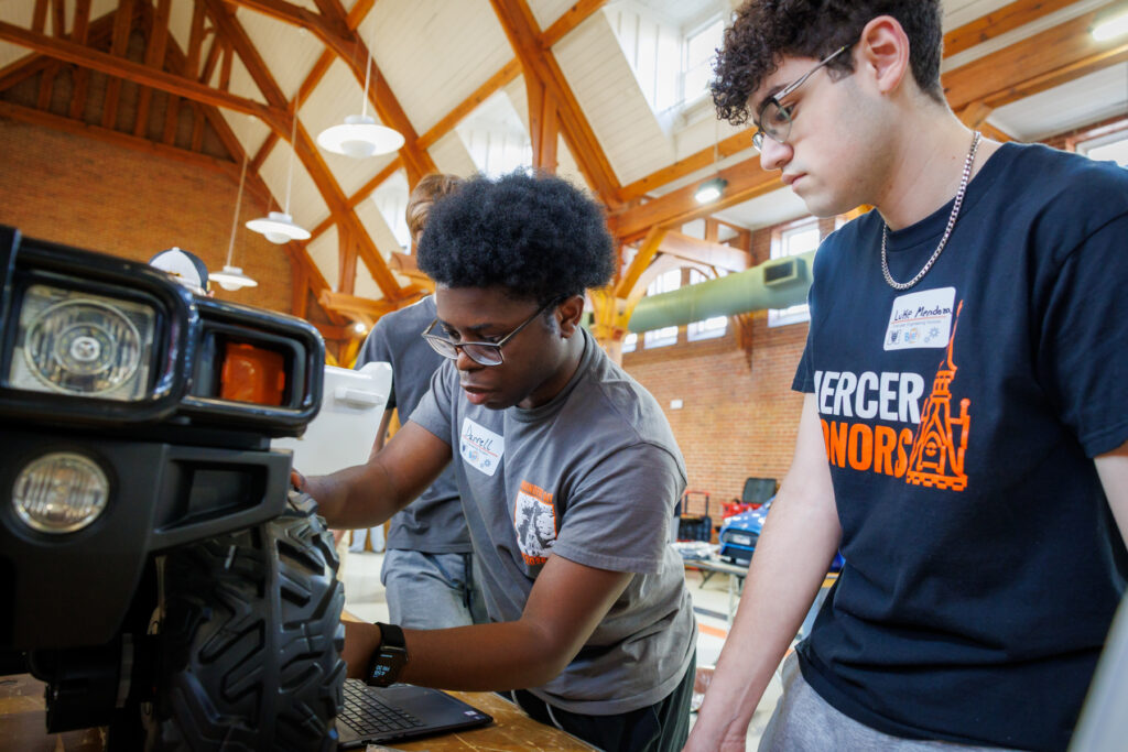 Mercer students work together on a modified toy car.