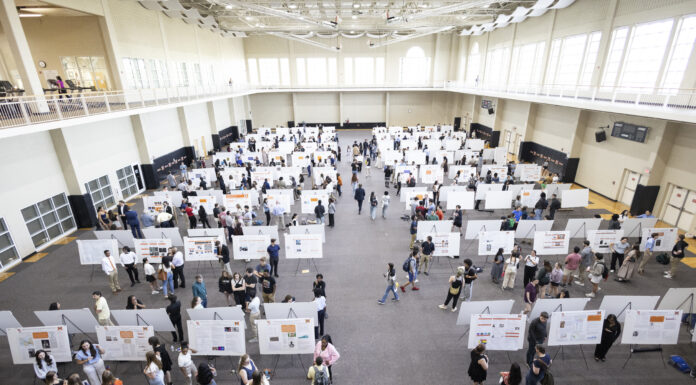 16th annual BEAR Day to showcase research, special projects in Macon Large indoor hall with many people viewing and discussing research posters displayed on white boards arranged in rows.