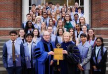 College of Liberal Arts and Sciences inducts 44 students into Phi Beta Kappa Society A group of students and faculty in academic regalia pose on steps, holding a large Phi Beta Kappa key symbol.