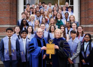 College of Liberal Arts and Sciences inducts 44 students into Phi Beta Kappa Society A group of students and faculty in academic regalia pose on steps, holding a large Phi Beta Kappa key symbol.