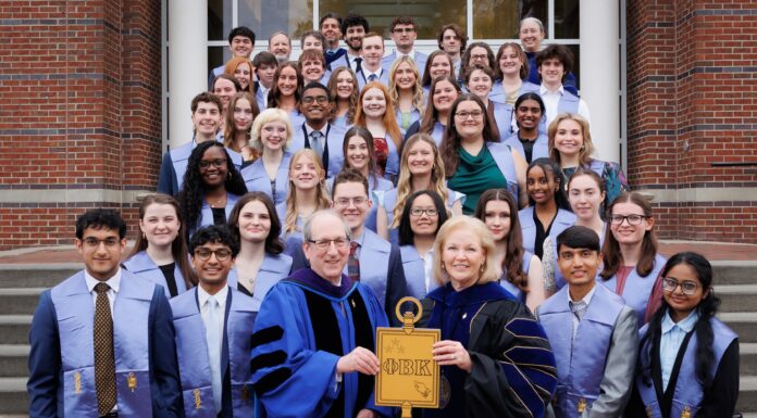 College of Liberal Arts and Sciences inducts 44 students into Phi Beta Kappa Society A group of students and faculty in academic regalia pose on steps, holding a large Phi Beta Kappa key symbol.