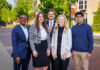 Fellows build leadership, character while working alongside Mercer president Five professionally dressed people stand and smile outside on a brick walkway with trees and buildings in the background.