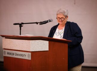 Engineering dean honored with 2026 Mike MacCarthy Mentoring Award An older woman stands at a podium labeled Mercer University, speaking into a microphone.