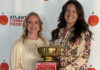Mercer Law wins 15th Georgia Legal Food Frenzy with record amount raised Two women holding a gold trophy with a plaque, standing in front of an Atlanta Community Food Bank banner.