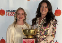Mercer Law wins 15th Georgia Legal Food Frenzy with record amount raised Two women holding a gold trophy with a plaque, standing in front of an Atlanta Community Food Bank banner.